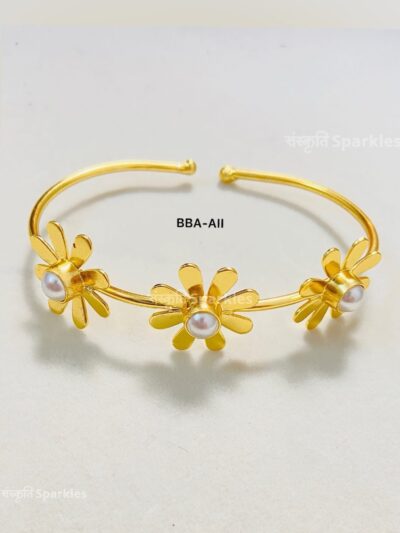 Elegant gold-plated floral cuff bracelet with pearl accents for a timeless charm.