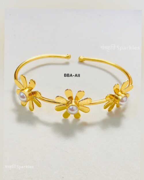Elegant gold-plated floral cuff bracelet with pearl accents for a timeless charm.