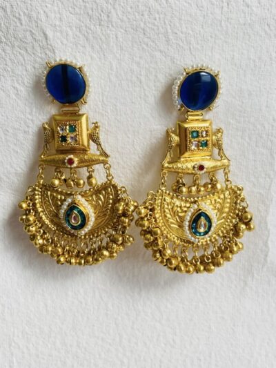Royal-inspired gold-plated statement brooch with intricate detailing and pearl embellishments.