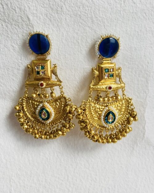 Royal-inspired gold-plated statement brooch with intricate detailing and pearl embellishments.