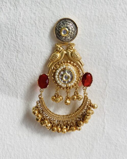 Elegant gold-plated brooch with intricate bird motifs and pearl embellishments.