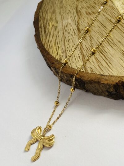 Grace tied in gold — the bow that speaks elegance