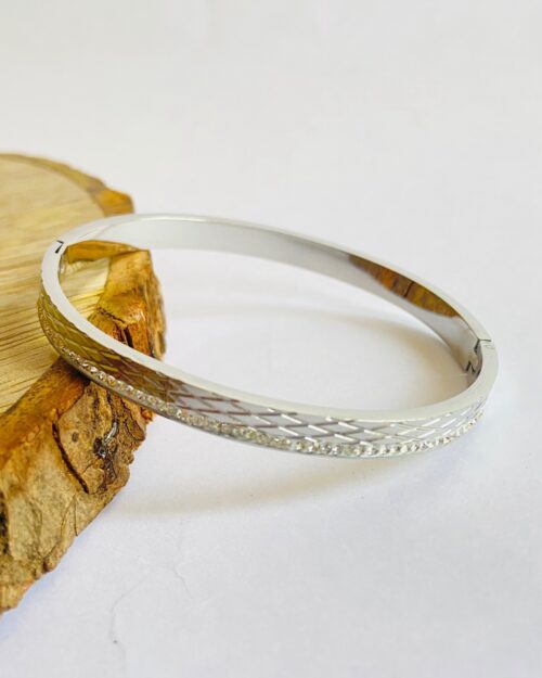 Sleek silver bangle with diamond-cut texture and elegant stone detailing - Image 3