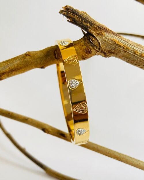 Modern gold bracelet with teardrop crystal accents—where shine meets sophistication